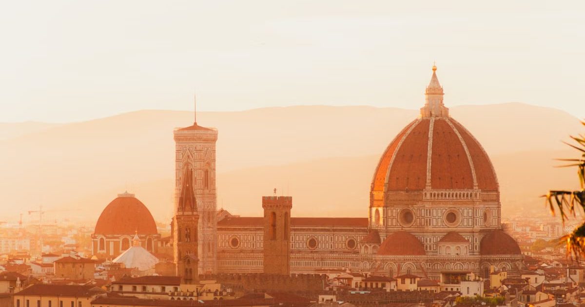 Breathtaking view of Florence Duomo at sunset, showcasing Renaissance architecture bathed in golden light.