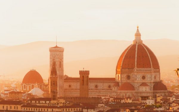 Breathtaking view of Florence Duomo at sunset, showcasing Renaissance architecture bathed in golden light.